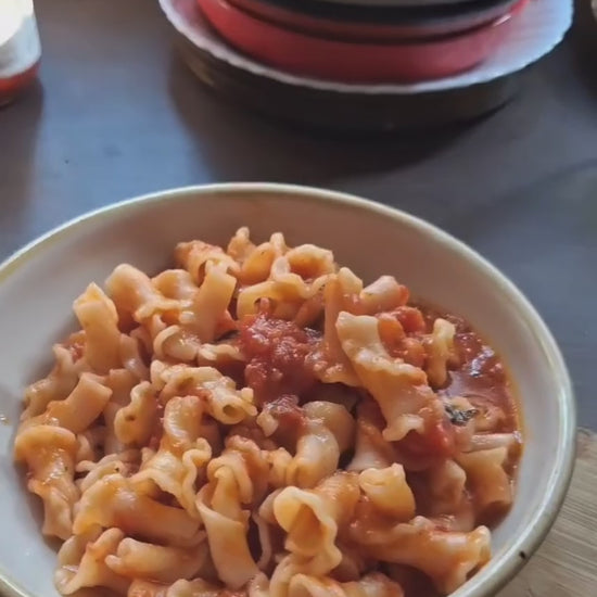 Dish of pasta tossed in Marinara sauce by Pass Me Summore 