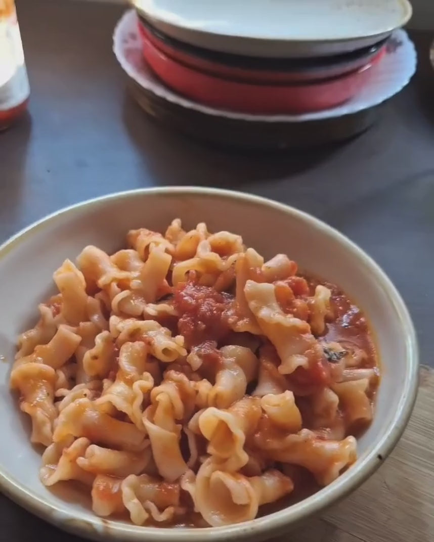 Dish of pasta tossed in Marinara sauce by Pass Me Summore 